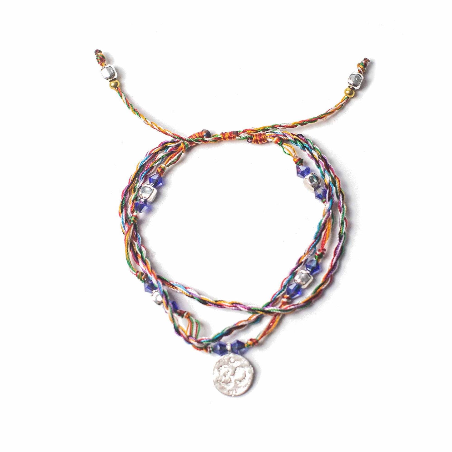 Multicolored braided bracelet with a silver charm on a white background