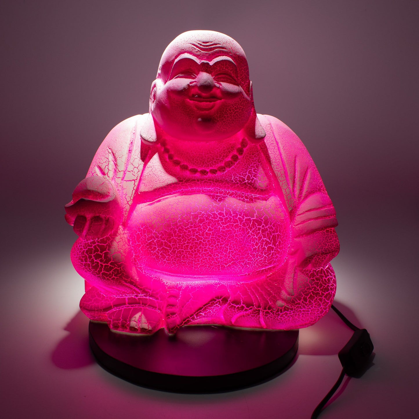 Pink Buddha lamp with cracked texture on a dark background