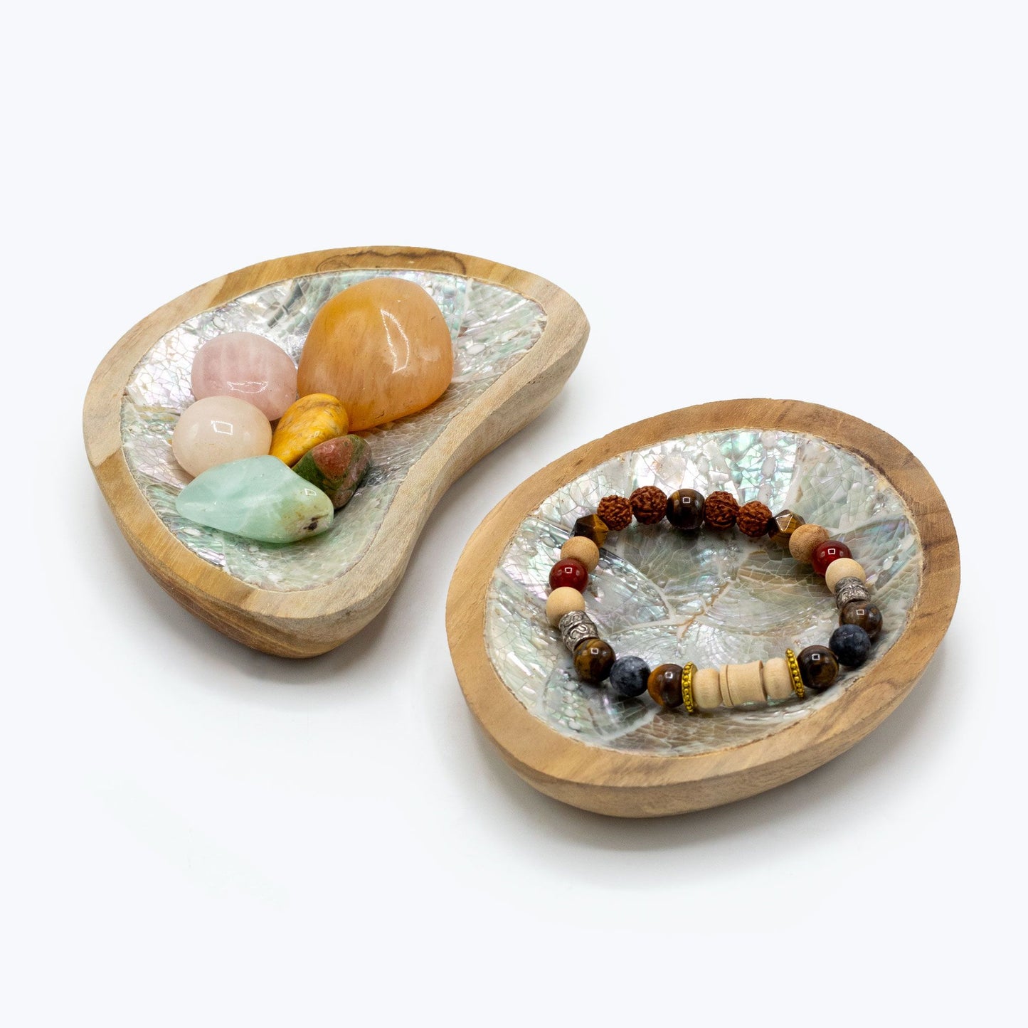 Two wooden trays with shell and stone decorations on a white background