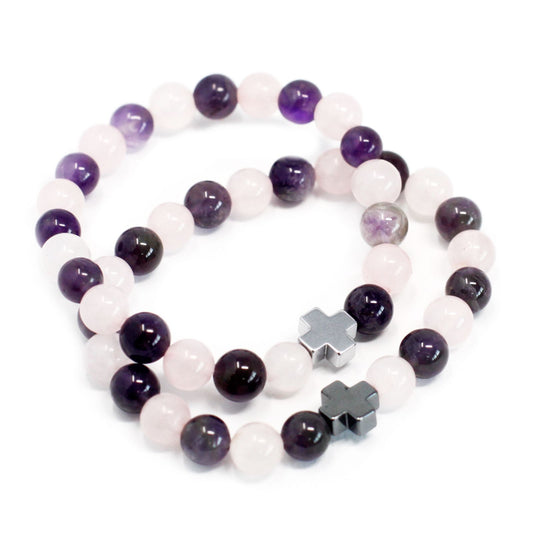 Two beaded bracelets with purple and white beads and silver star-shaped charms on a white background.