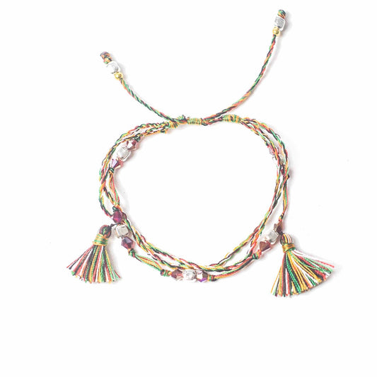 Colorful braided necklace with tassels on a white background