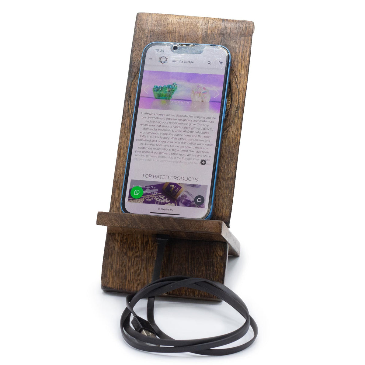 Wooden phone stand holding a smartphone with a white background