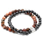 Two beaded bracelets with black and red beads on a white background