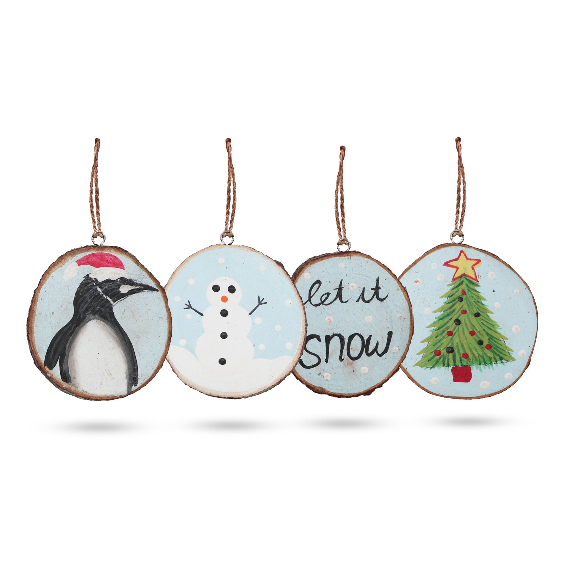 Set of four Christmas-themed ornaments with penguin, snowman, and tree designs on a white background.