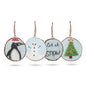 Set of four Christmas-themed ornaments with penguin, snowman, and tree designs on a white background.