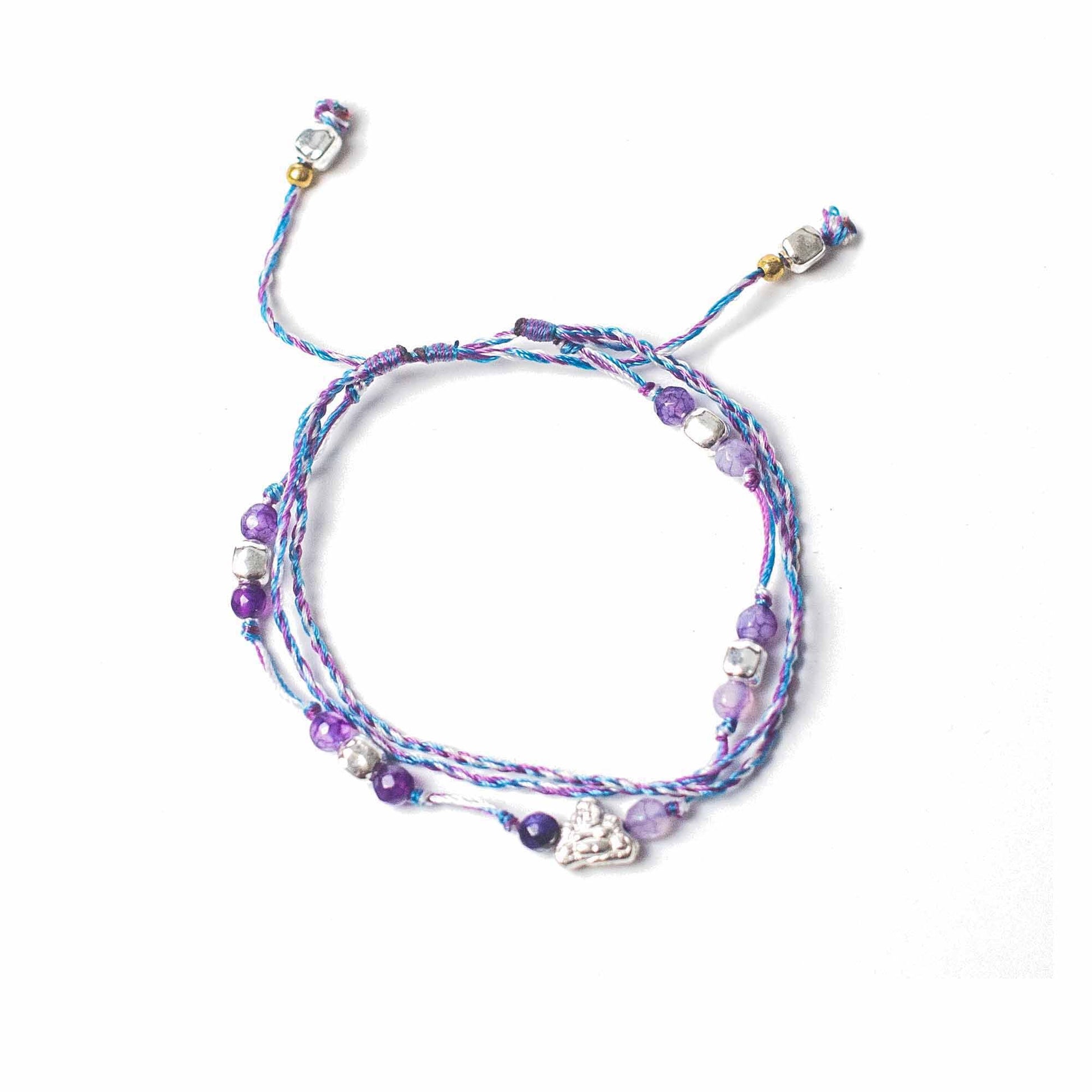 Multicolored beaded bracelet with charms on a white background