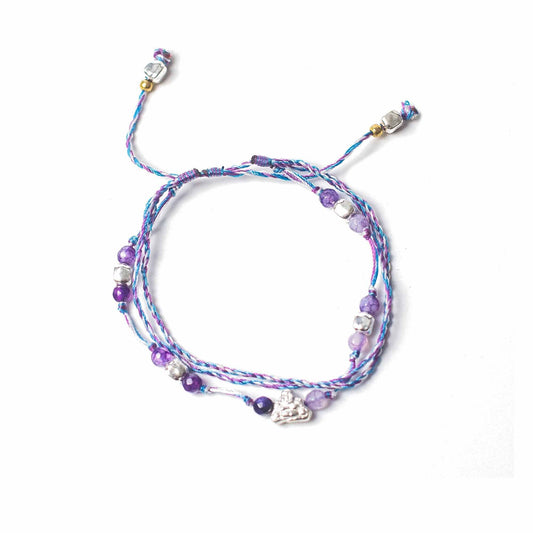Multicolored beaded bracelet with charms on a white background