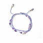 Multicolored beaded bracelet with charms on a white background