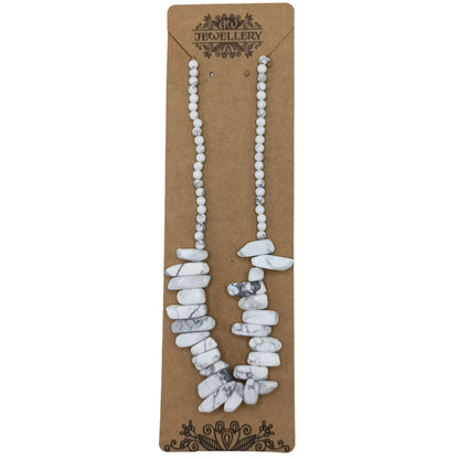 Necklace with white stones on a brown card with 'Jewellery' branding.