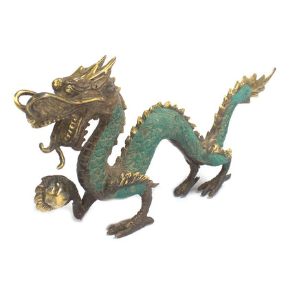 Bronze and green dragon figurine on a white background