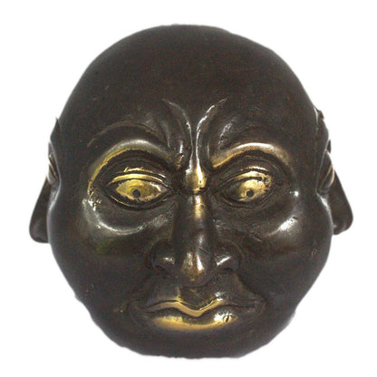 Bronze mask with gold accents on a white background