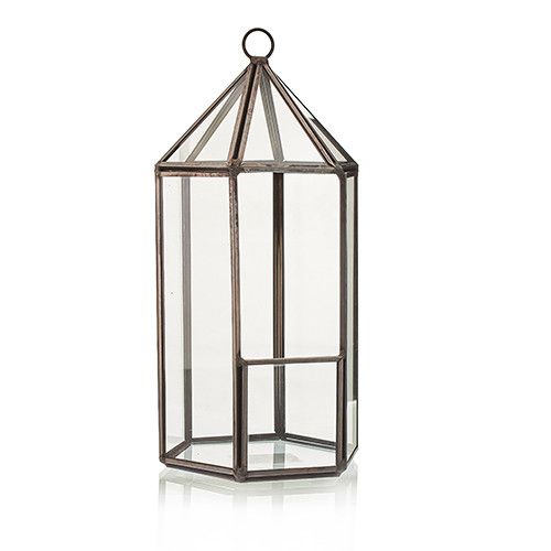 Tall glass lantern with metal frame on a white background