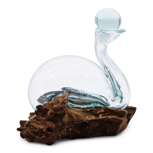 Glass sculptured decanter of a duck with a transparent body and brown base on a white background
